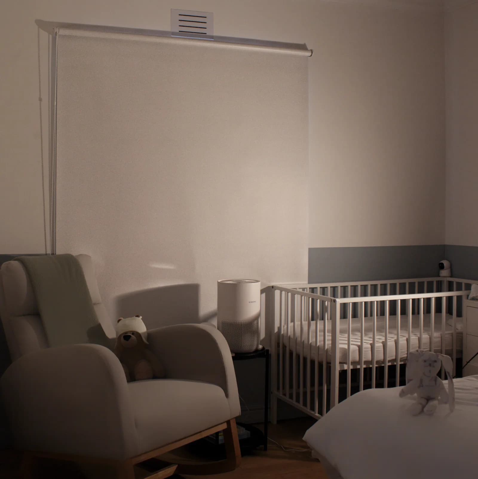 Blockout roller blind fully extended in a warmly lit nursery at bedtime